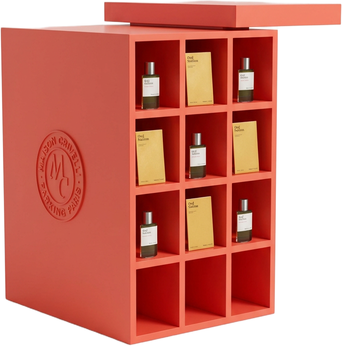 Angled view of the red cubby tower holding Oud Stallion fragrance bottles